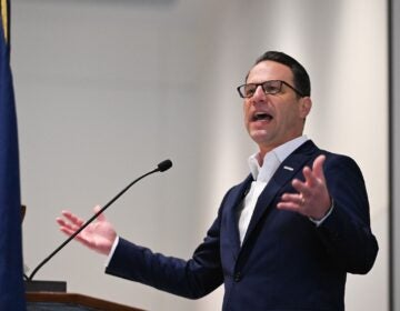 Josh Shapiro is speaking at a podium.