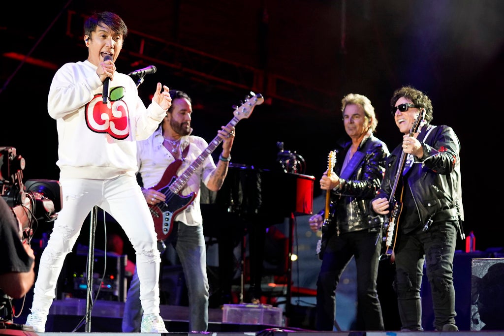 Arnel Pineda, Marco Mendoza, Jonathan Cain, and Neal Schon, of the band Journey, perform at Lollapalooza