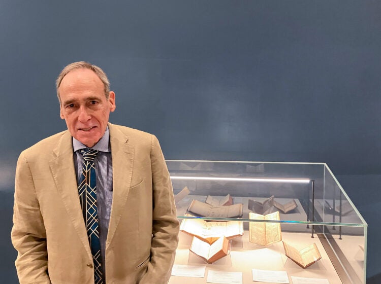 Selby Kiffer posing for a photo in front of a display case.