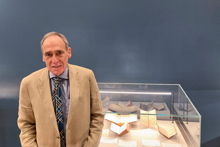 Selby Kiffer posing for a photo in front of a display case.