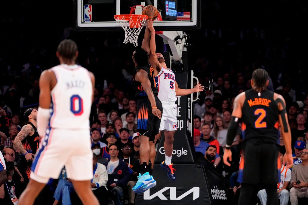 New York Knicks forward Og Anunoby, center left, blocks Philadelphia 76ers guard Quentin Grimes