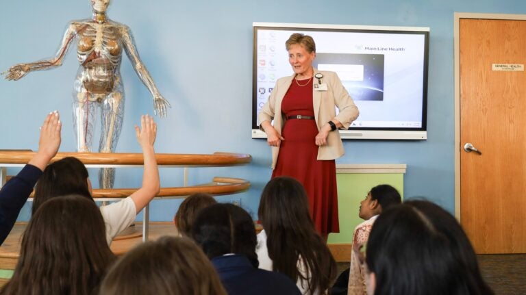 Maureen Krouse gives an anatomy lesson to sixth-grade students