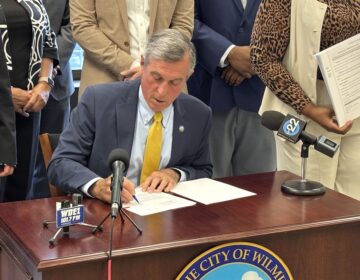 John Carney signing bill for Wilmington's 2027 budget