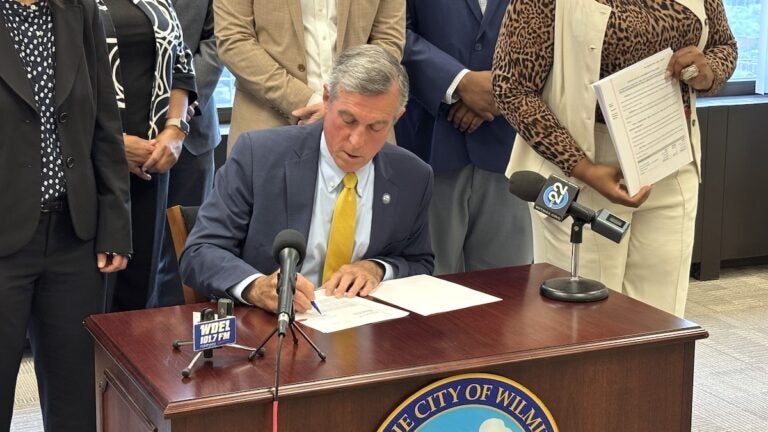 John Carney signing bill for Wilmington's 2027 budget
