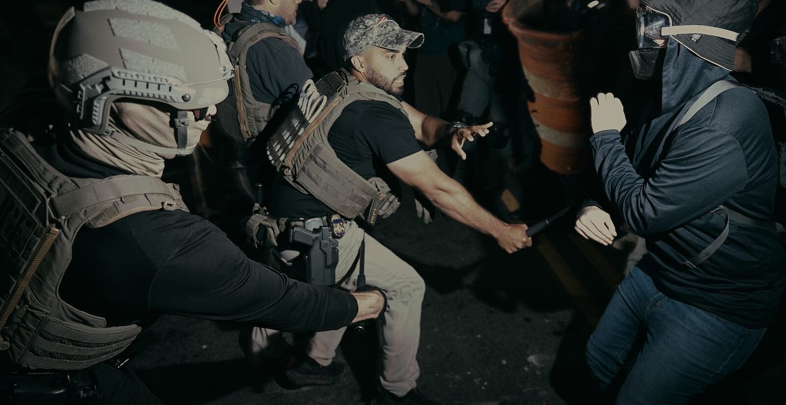 ICE agents use their baton as they clash with protesters outside the Delaney Hall detention center during a protest on Wednesday, May 27, 2026, in Newark, N.J.