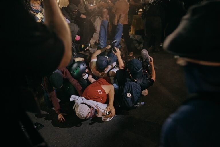 Protesters and media are thrown on the road by ICE agents outside the Delaney Hall detention during a protest on Wednesday, May 27, 2026, in Newark, N.J. Inside the facility, detainees carried out a labor and hunger strike for days over alleged living conditions.