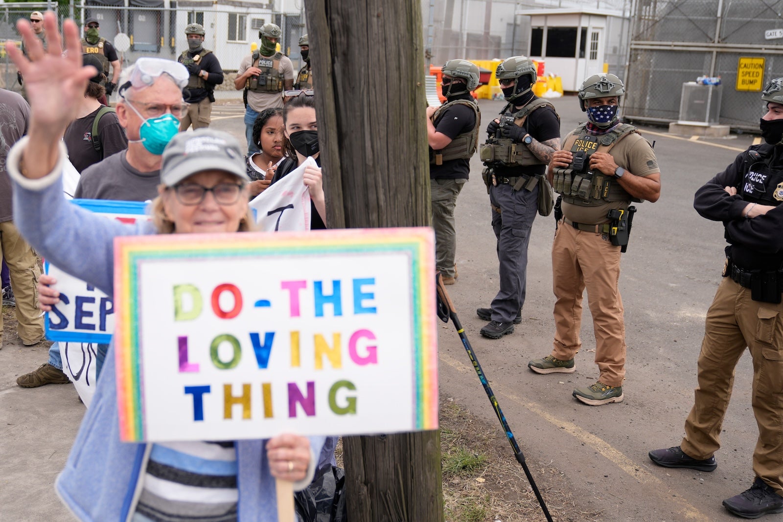 Masked federal agents stand outside the Delaney Hall detention center during a protest against the transfer of detainees on Wednesday, May 27, 2026, in Newark, N.J.