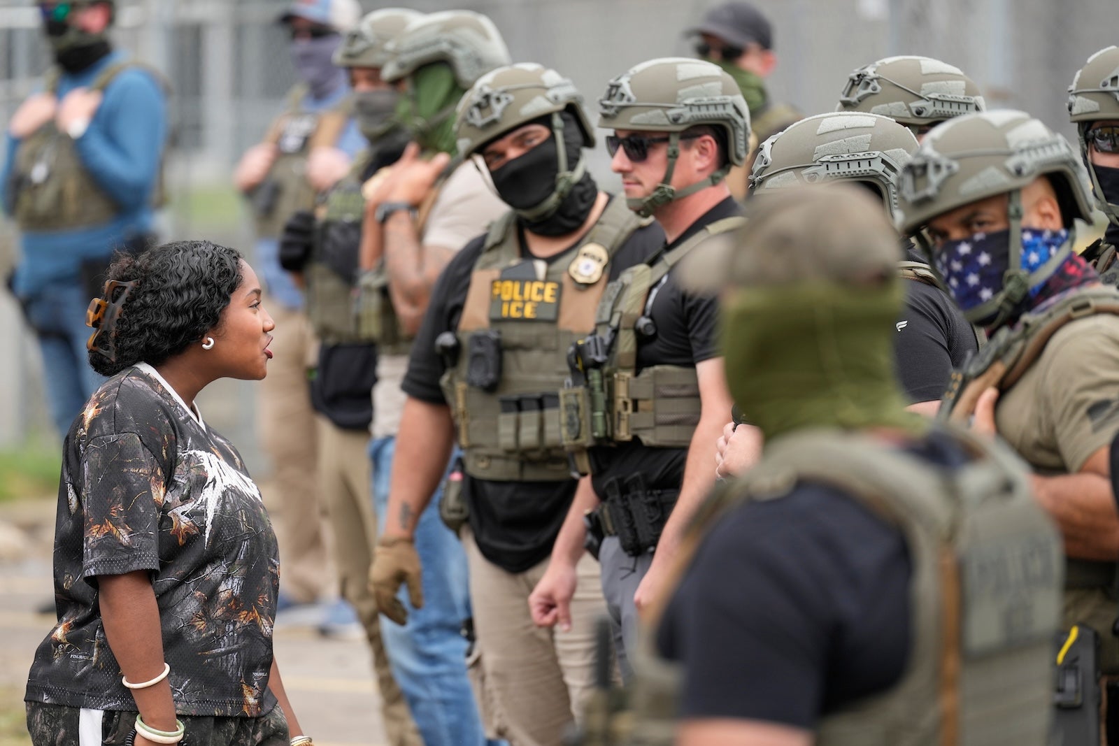A protester talks to masked federal agents standing outside the Delaney Hall detention center during a protest against the transfer of detainees on Wednesday, May 27, 2026, in Newark, N.J.