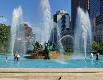 People cool off at Swann Memorial Fountain in Philadelphia's Logan Square on May 18, 2026.