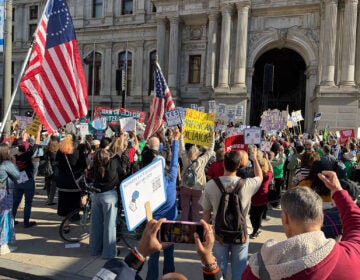 Unions and labor activists rally at City Hall to commemorate Mayday