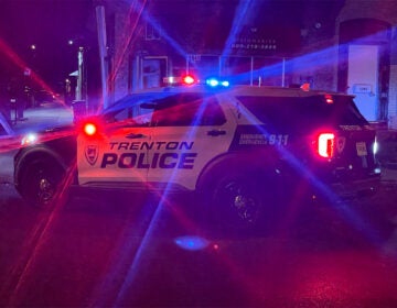 trenton-police-k-burns-2022-09-23 A Trenton Police car is parked in the street at night with it's siren flashing