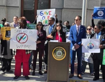 Anti-Waymo protestors gathered outside City Hall