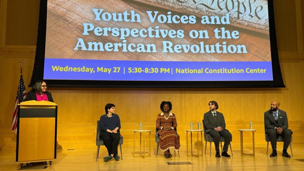 Sarah Glover leading a panel discussion