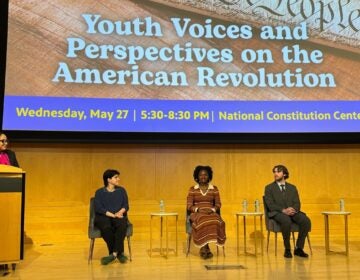 Sarah Glover leading a panel discussion