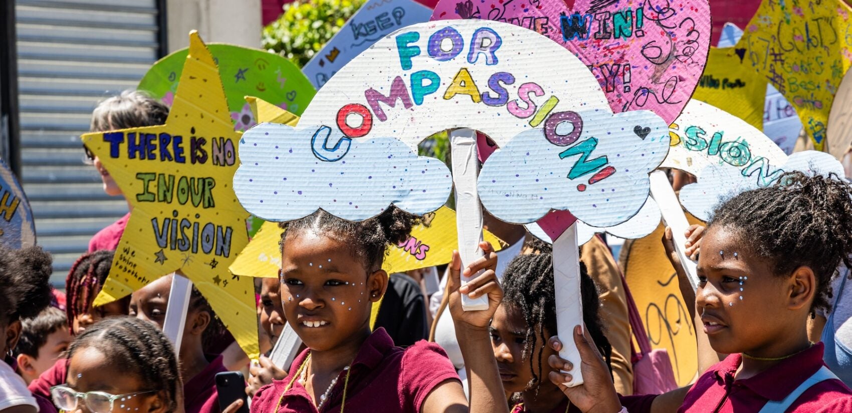 School children have a parade with their large puppets and signs.