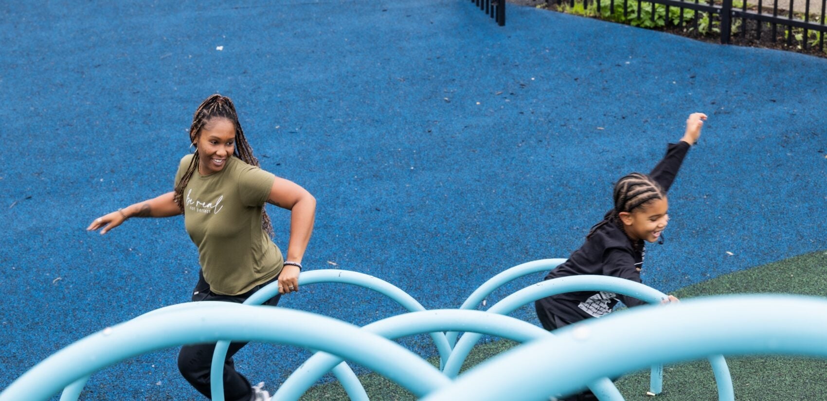Christina Allen and her son running around a playground.