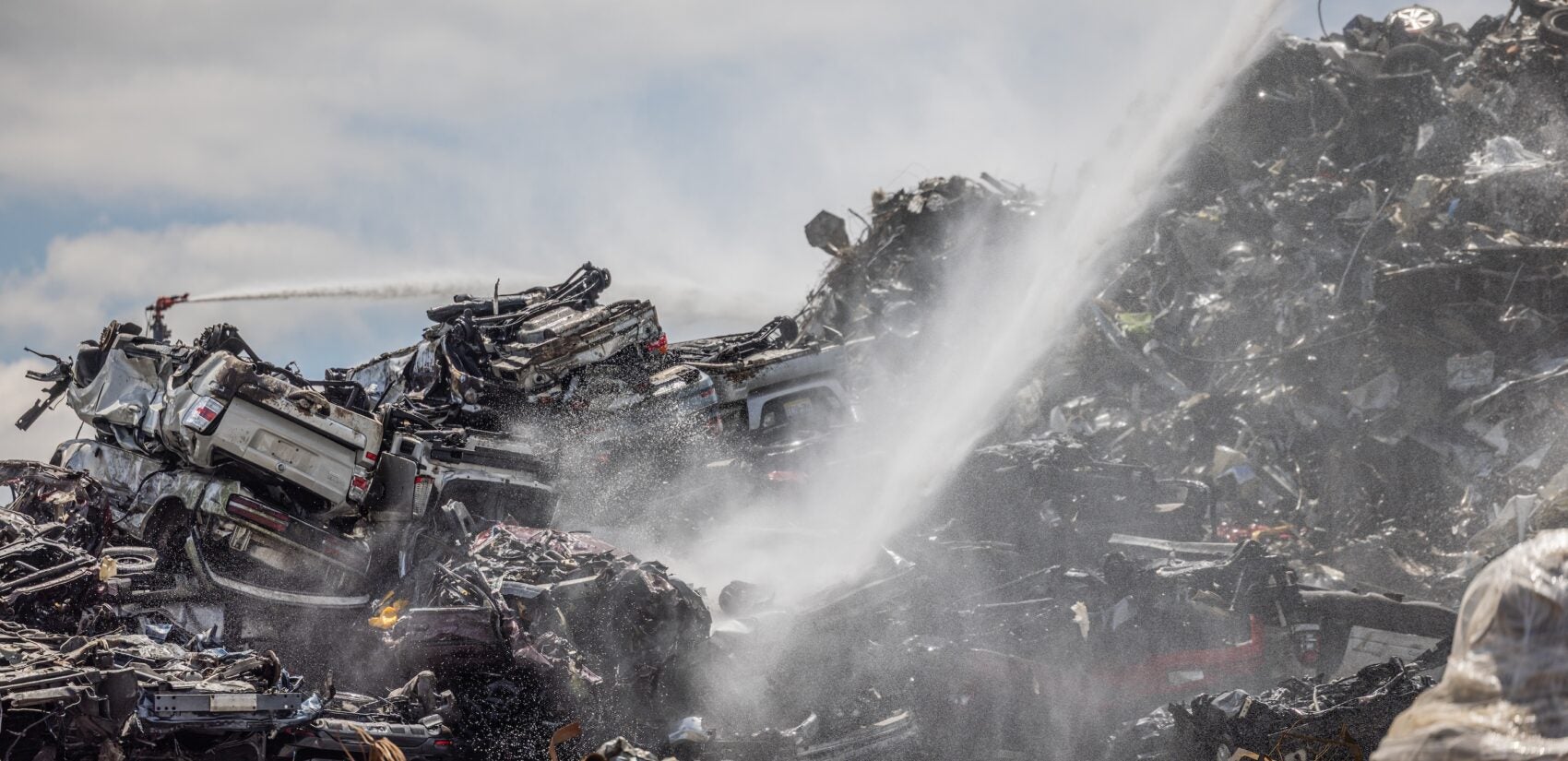 Pouring water onto the scrap pile.