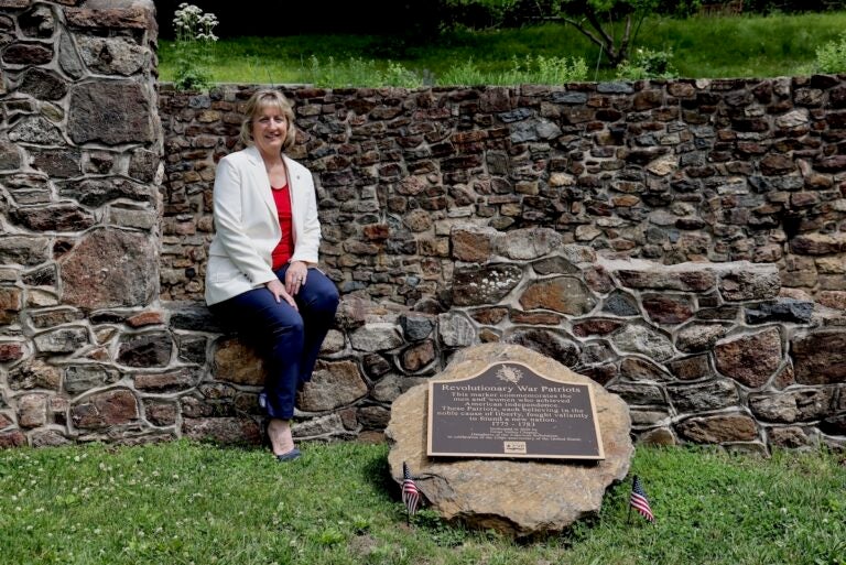 Karen Christen poses for photo at ruins of American revolutionary war