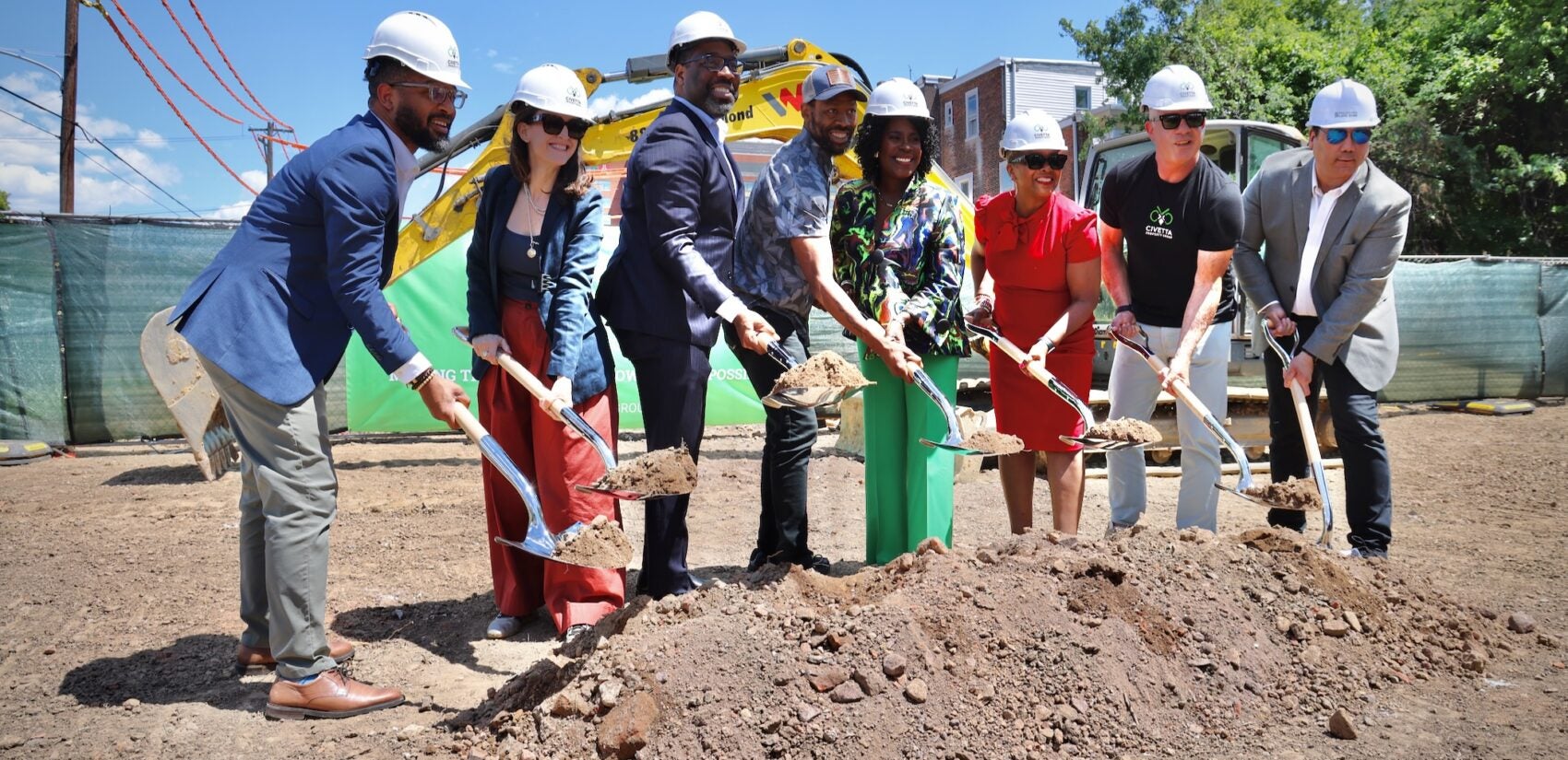 Mayor Parker and other officials hold shovels with dirt at the groundbreaking.