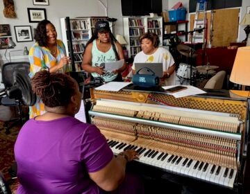 2026 06 08-p crimmins-kendrah butler waters jos duncan ase ellemorris lauren lark-philadelphia germantown-pepperpot composer Kendrah Butler-Waters is playing the piano, while a group of singers are rehearsing with her.