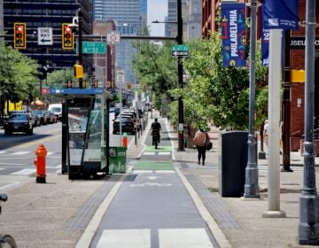 2026 06 09-e lee-philadelphia old city market street-major renovation bicycle A bicyclist uses the sidewalk-level bike lane