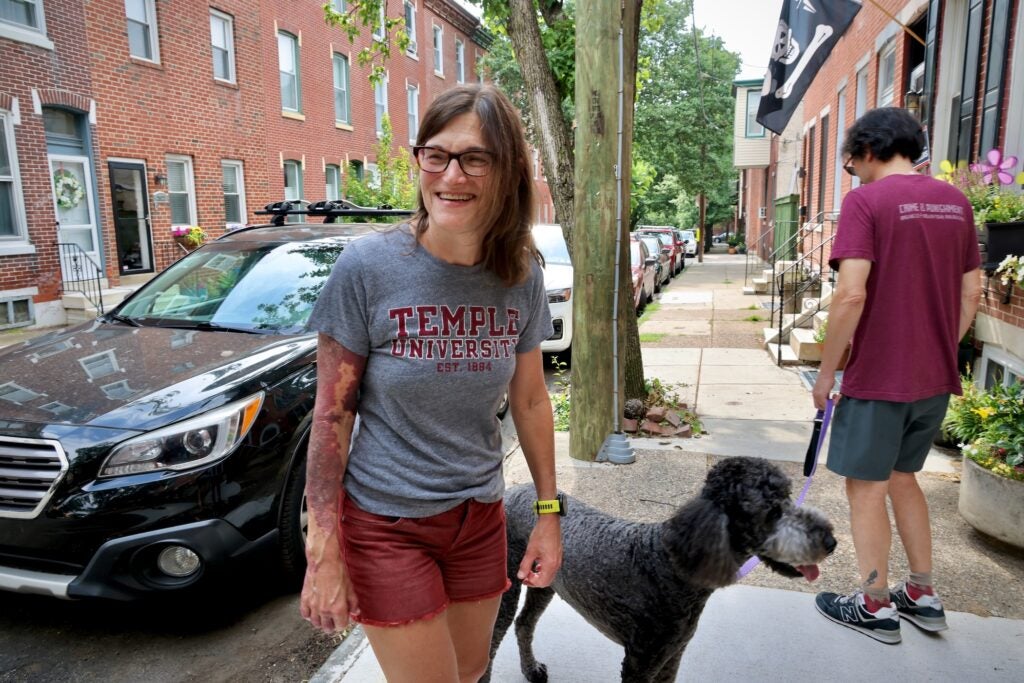 Jill Becaris poses for a photo while out walking her dog.