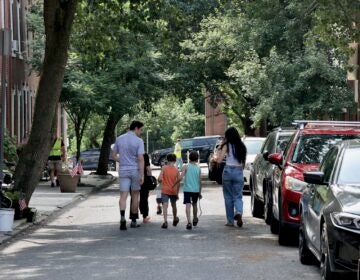 2026 06 10-e lee-philadelphia fairmount-fifa fan fest community preview family A family walks down the street.