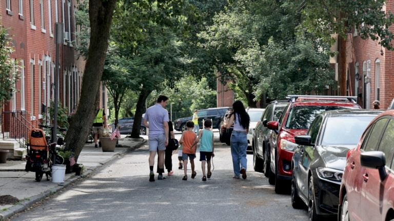 A family walks down the street.
