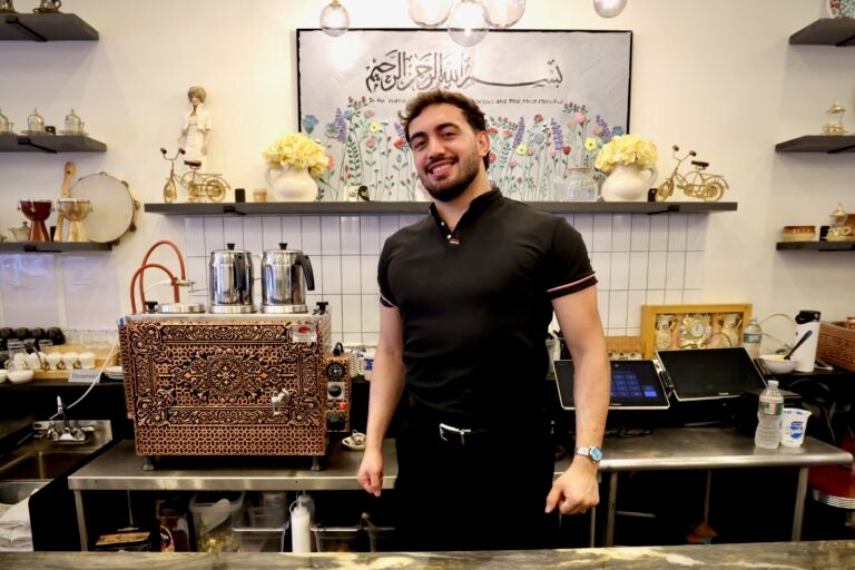 Muhammed Emanet stands behind the counter at his family's restaurant, Jersey Kebab