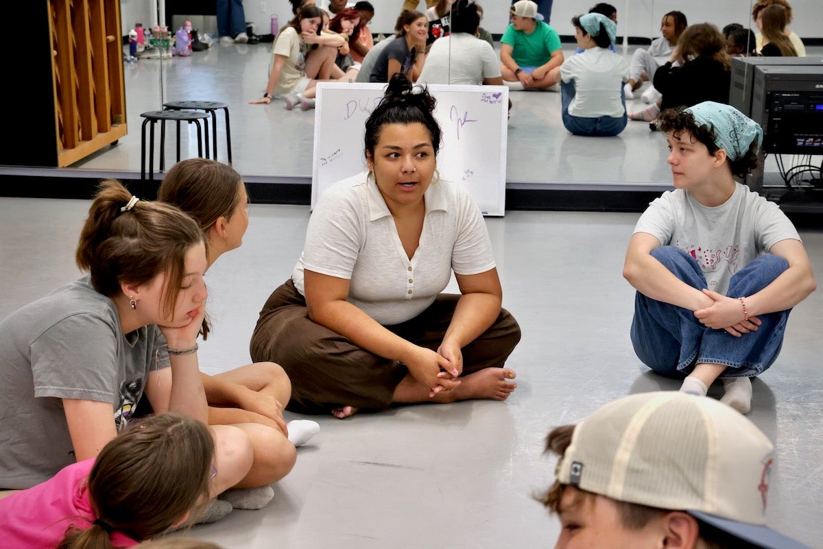 Valentina Sierra (center) plays music for a music class