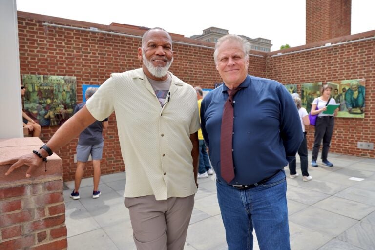 Kevin Douglass Green and Brian Evans pose for a photo at the President's House exhibit.