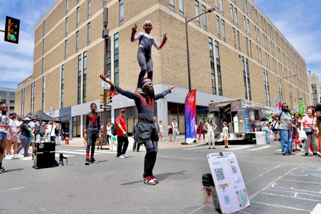 Acrobats performing in the street during the party.