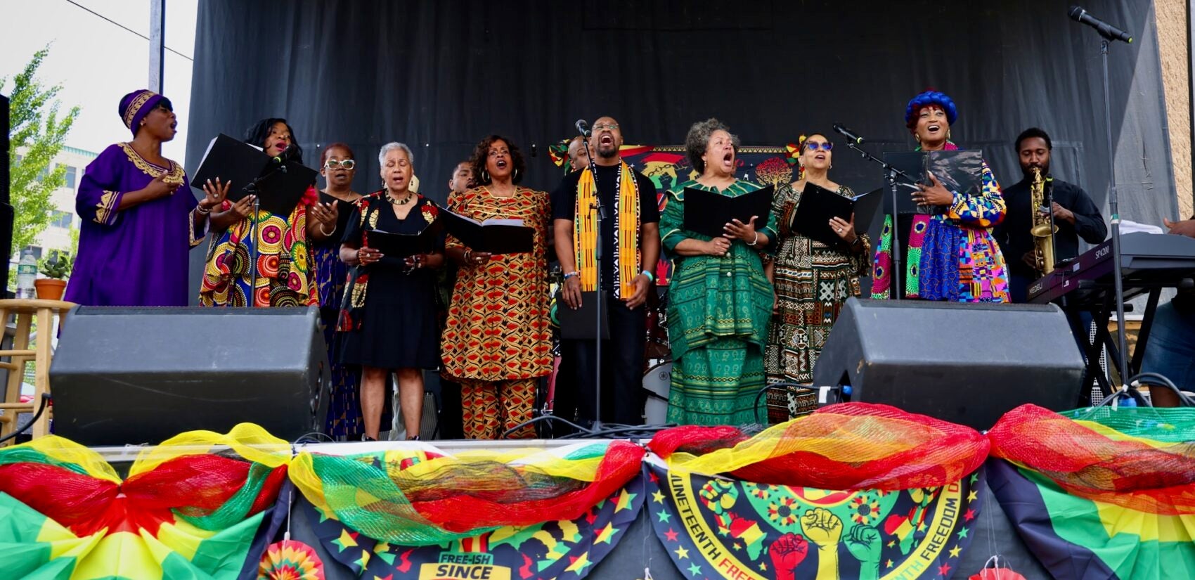 Members of a chorus singing on stage.