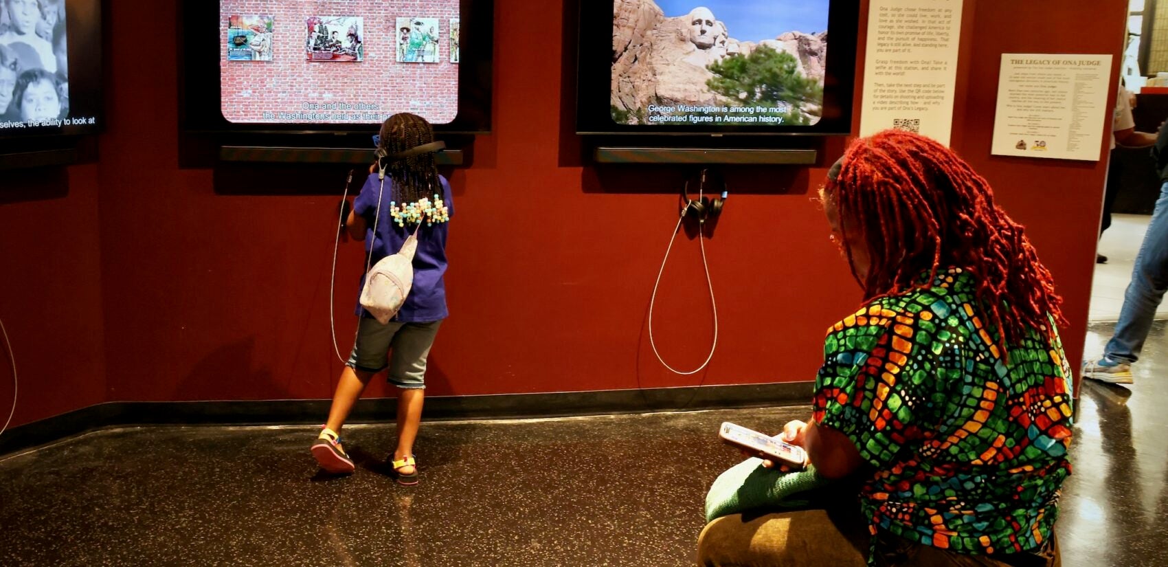 People looking at the exhibit in the museum.