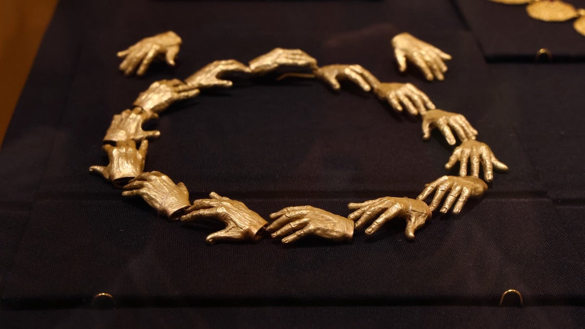 Betsy Wyeth wore jewelry modeled on motifs from her husband's paintings, such as a necklace and earings based on the disembodied hands in Andrew Wyeth's ''Breakup.'' (Emma Lee/WHYY)