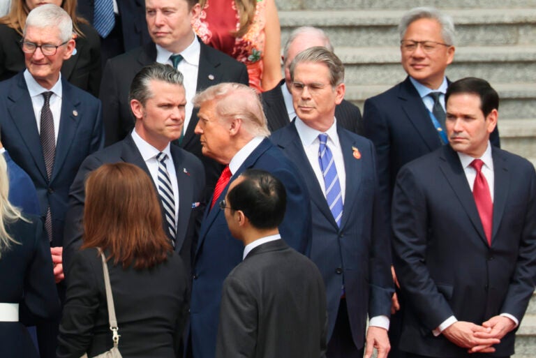 U.S. President Donald Trump looks on next to, from bottom right, U.S. Secretary of State Marco Rubio, U.S. Treasury Secretary Scott Bessent, U.S. Defense Secretary Pete Hegseth, Nvidia CEO Jensen Huang, top right, Tesla CEO Elon Musk, Apple CEO Tim Cook, top left, and others during a welcome ceremony at the Great Hall of the People in Beijing, Thursday, May 14, 2026. (Maxim Shemetov/Pool Photo via AP)