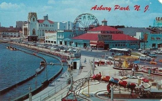 An old postcard of Asbury Park, New Jersey that shows a ferris wheel along the shoreline