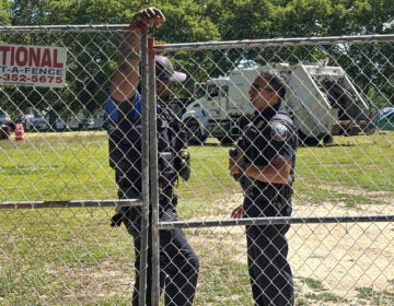 Police-Christina-s-mueller-2026-06-15 Two police officers stand by a fence