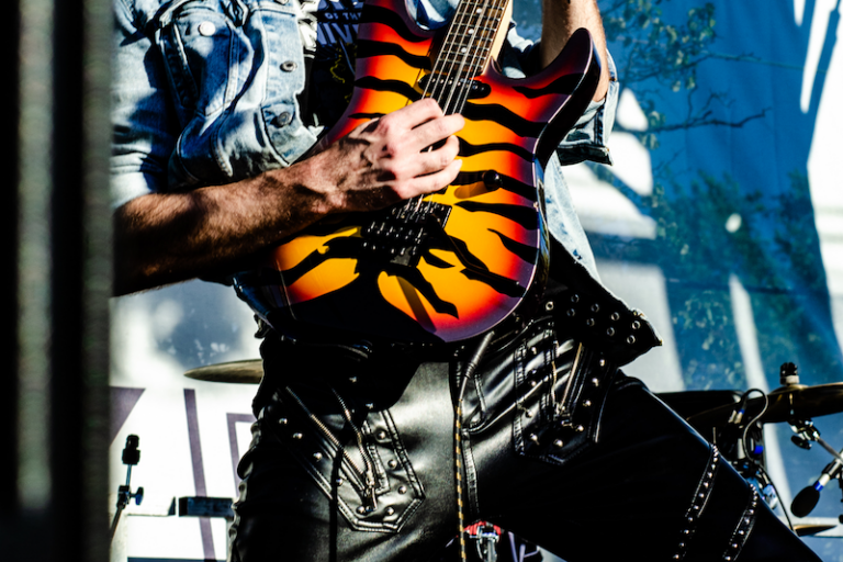 Kyle Willans on stage playing guitar