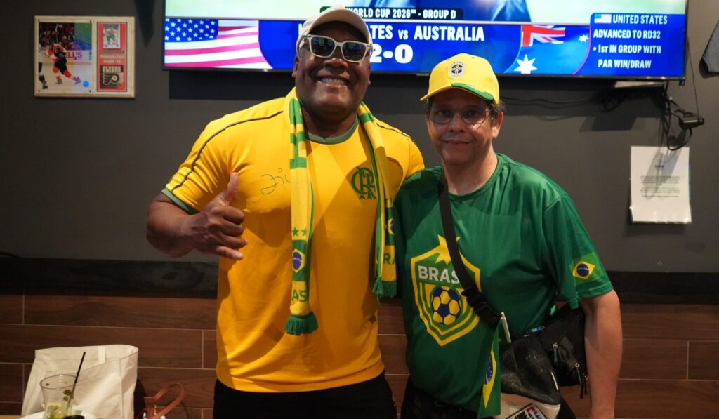 Marcelo Nuba and Juliano Telles pose for a photo in the bar.