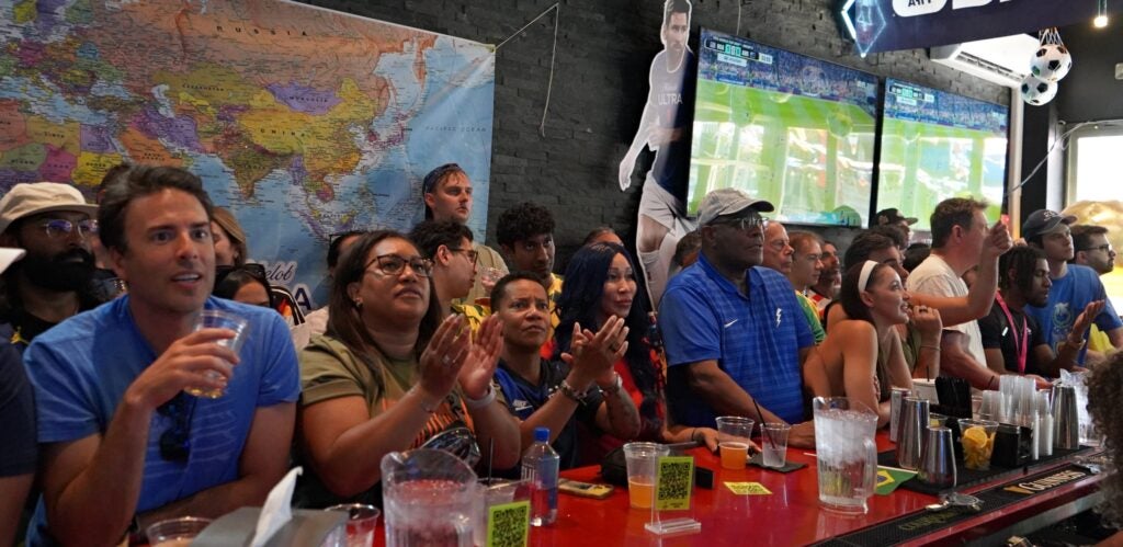 People watching the game at the bar