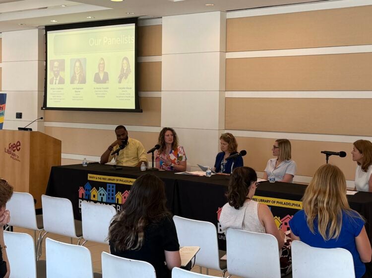 bridging-blocks-2026-06-19 Panelists sit at a table with microphones for the panel discussion