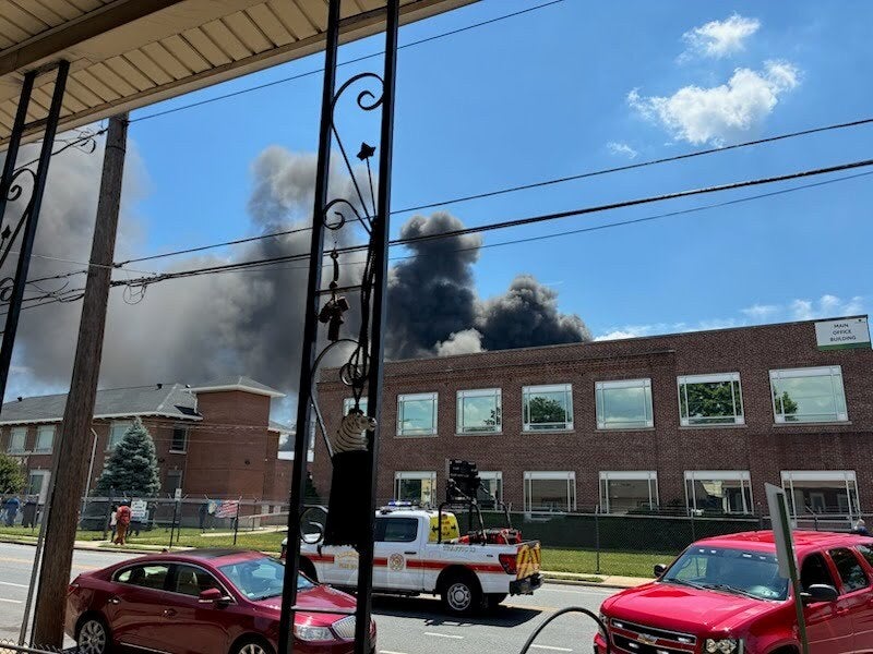 Smoke from the Monroe Energy petroleum refinery fire rises over buildings