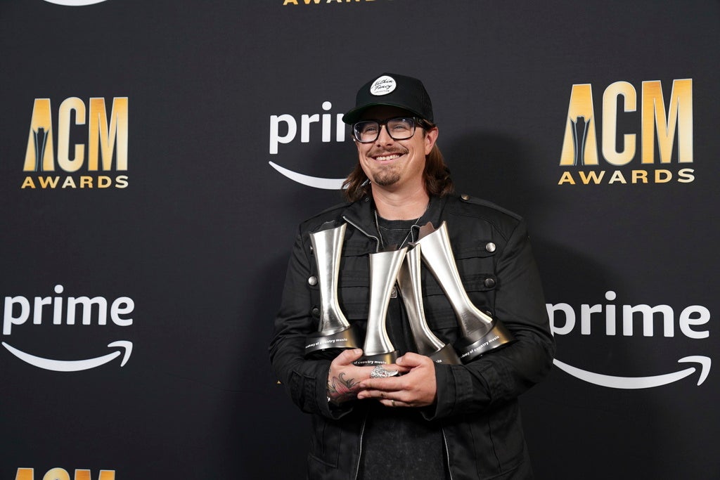 Artist HARDY poses with trophies he won