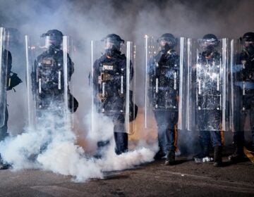APTOPIX Immigration Protests New Jersey State police officers stand behind shields as tear gas fills the area outside the Delaney Hall detention center during a protest against the transfer of detainees and federal immigration policies, Friday, May 29, 2026, in Newark, N.J.