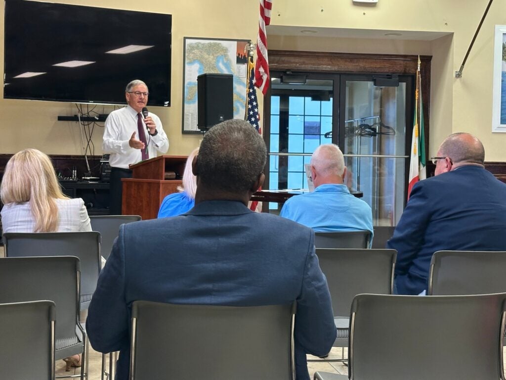 Jon Bramnick speaking at a podium addressing a small group of people.