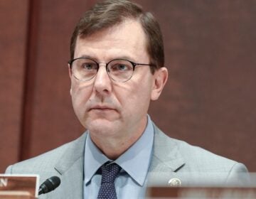 Tom Kean sitting behind the table during a congressional hearing.