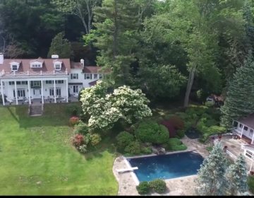 An aerial view of a large estate with a swimming pool.
