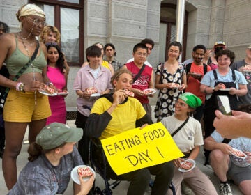 A person in a wheelchair eat a piece of bread with the words 