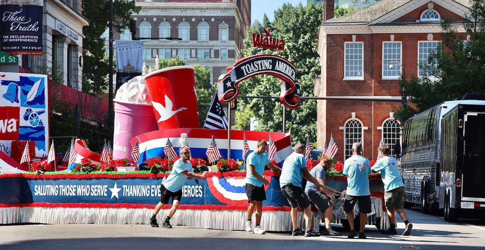 Workers turn a float around on Fifth Street after Philadelphia’s Fourth of July parade was canceled due to dangerously high temperatures.
